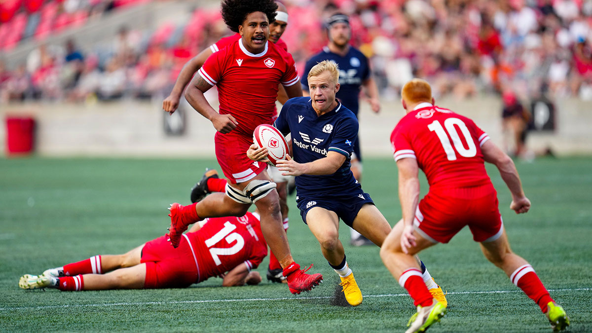 Arron Reed of Scotland runs at Canada defence during 2024 summer international