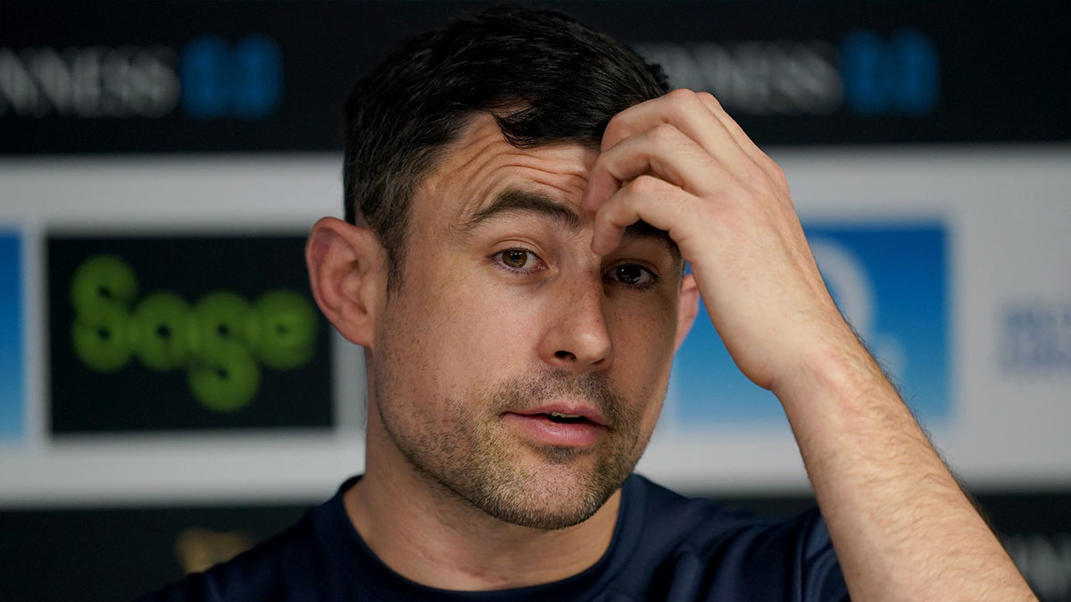 Felix Jones scratches his head at an England press conference