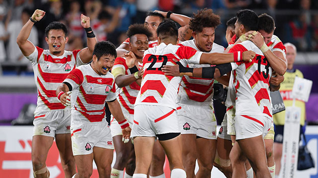 Japan players celebrate at the final whistle after beating Scotland at World Cup