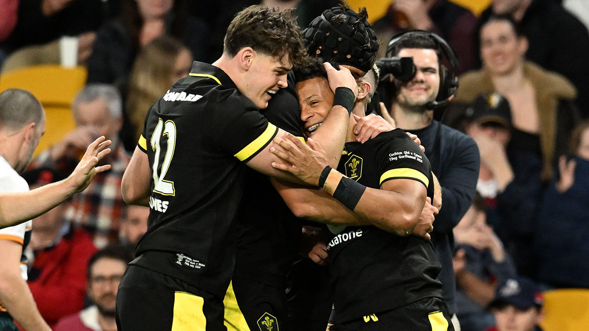 Regan Grace is congratulated by team mates after scoring a try for Wales v Queensland Reds during 2024 summer internationals