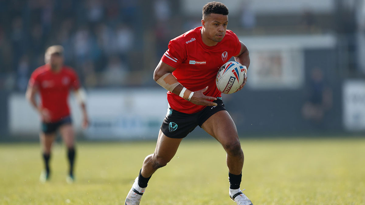 Regan Grace runs with the ball while representing St Helens